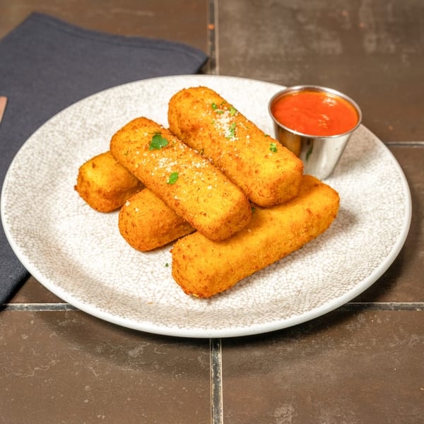 Five golden-brown mozzarella sticks with parmesan and parsley, served with a side of marinara sauce.